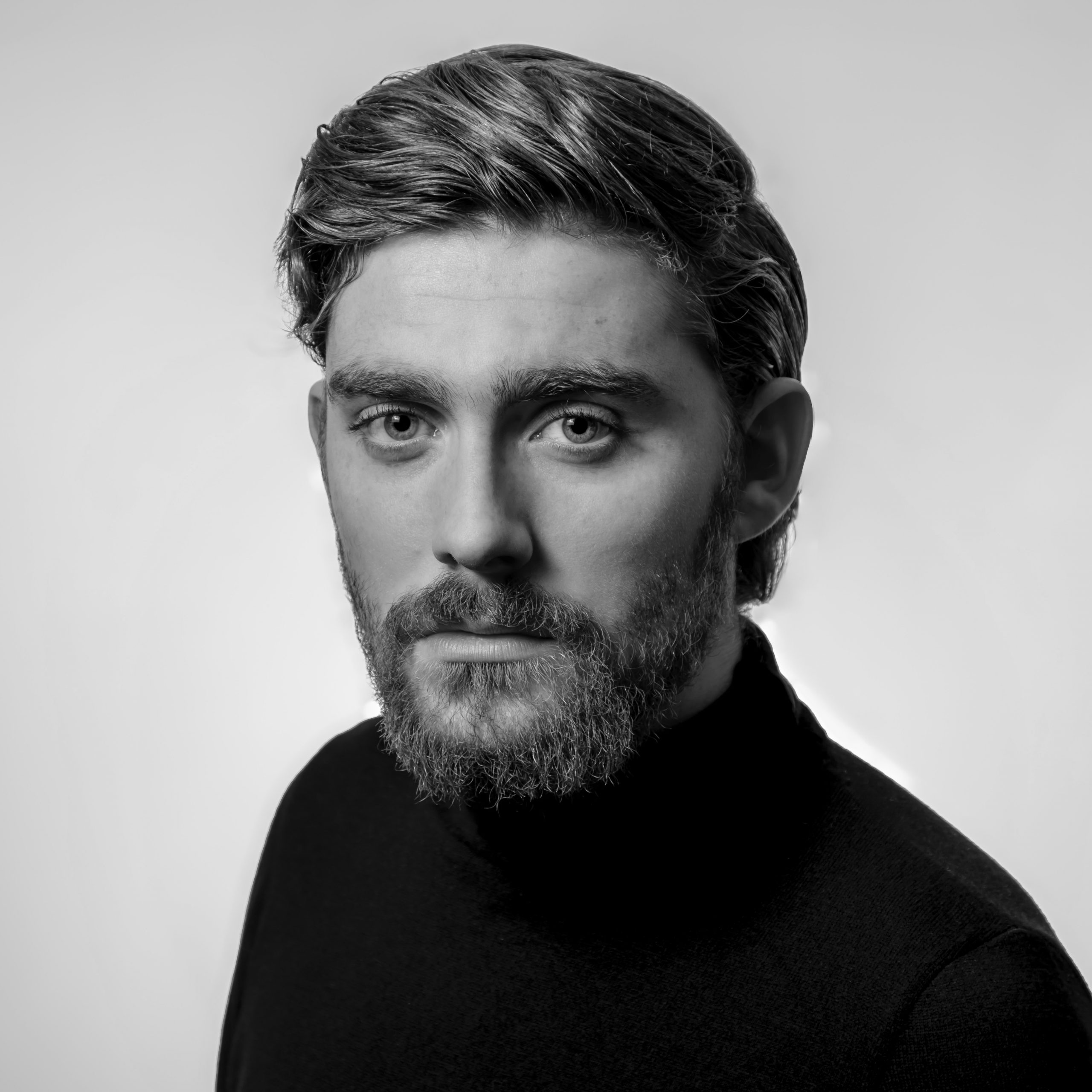 Black-and-white circular portrait of a man with short hair and a beard, wearing a dark top, looking directly at the camera. Positioned next to text that reads 'Jesse Payne’ and a short testimonial excerpt.